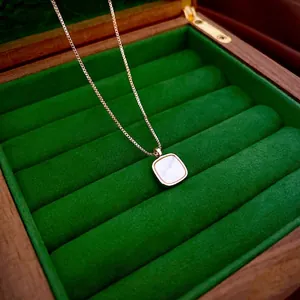Rose gold square pendant necklace with iridescent mother of pearl in a velvet jewelry box