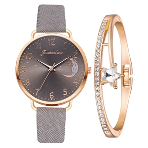 Detailed macro of rose gold watch with moon dial and crystal star charm bracelet