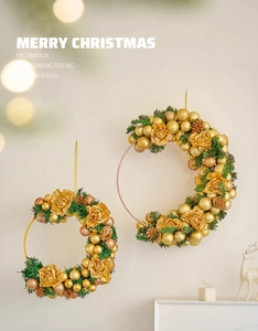 Detailed view of luxury gold Christmas wreaths with pine needles and fabric roses
