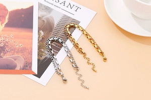 Detail of double-layer gold and silver steel chain bracelet with adjustable lobster clasp