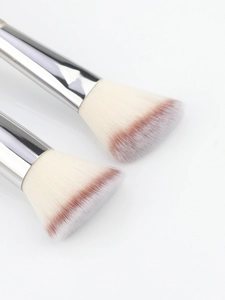 Close-up of champagne makeup brushes with soft gradient synthetic bristles and silver ferrule