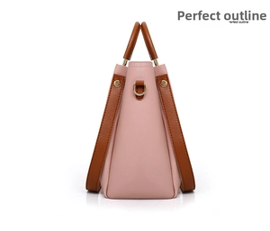 Detail view of pink and brown leather bucket bag showing side profile and gold hardware