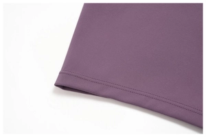 Close-up of double-needle stitching on purple brushed yoga set hem with fine knit texture