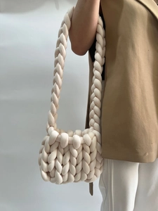 Detail of chunky knit shoulder bag in cream white showing thick woven cotton texture