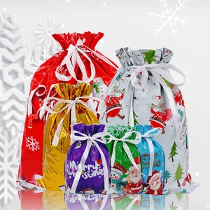 Detailed view of colorful drawstring Christmas gift bags with festive patterns and text
