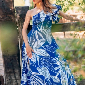 Detail of one-shoulder tropical leaf print dress with ruffled neckline for beach vacation