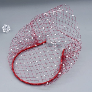 Close-up of elegant red bridal veil headband with sparkling crystal mesh detailing