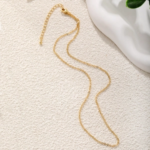 Detail of 45cm gold-plated minimalist link chain with adjustable extender and bead charm