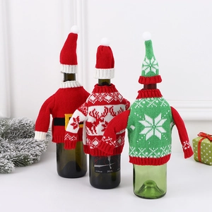 Three festive Christmas knitted wine bottle covers with Santa, deer and snowflake patterns