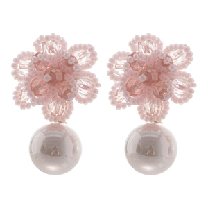 Pink beaded flower earrings with large white pearl drop on a minimalist white background
