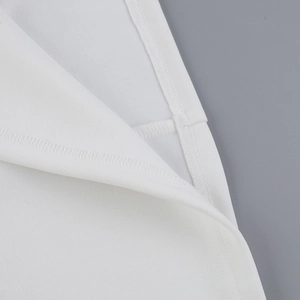 Close-up of neat flat seam edging and high-quality white fabric on a mini dress