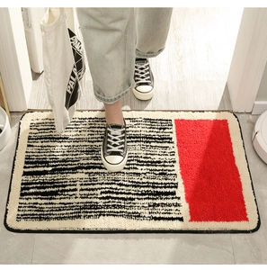 Macro view of striped bathroom floor mat with non-slip texture and red contrast detail