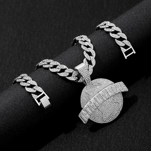 Close-up of silver Cuban link chain with iced-out THE WORLD globe pendant