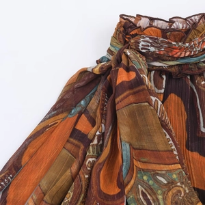Close-up of Bohemian printed chiffon fabric with golden thread and knot detail