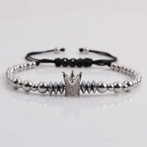 Detail of silver crown charm and beads on a black braided adjustable cord bracelet