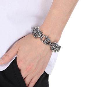 Detailed close-up of retro silver tiger head charm on a punk style titanium steel bracelet