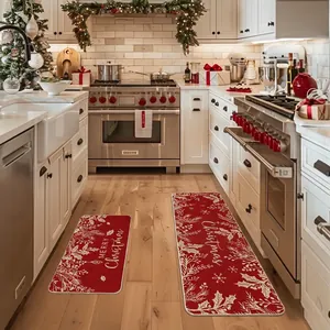 Detailed close-up of a two-piece red Christmas kitchen mat set on a light wood floor