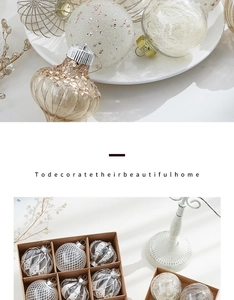 Detail of champagne Christmas ornaments with sequins and grid texture in a kraft paper box