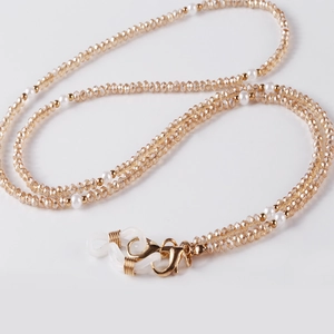 Detail of champagne crystal beads and white pearls on a multifunctional glasses chain