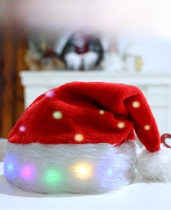 Detail of red plush Christmas hat with colorful LED lights and soft white faux fur trim