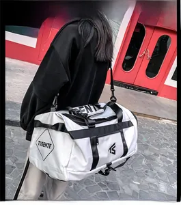 Close-up of a white Oxford fabric sports bag featuring black straps and TUSENTE branding