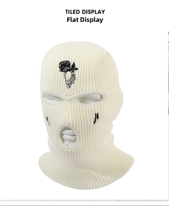 Close-up of white 3-hole knitted ski mask with black rose and musical note embroidery