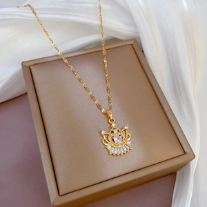 Luxury gold plated crown necklace with heart zircon pendant on white silk background