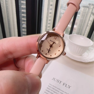 Elegant women quartz watch featuring pink leather strap and rose gold case on a hand