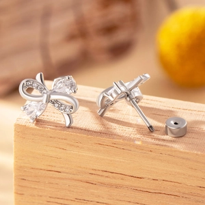 Elegant silver bow stud earrings with sparkling crystals and secure screw back closure
