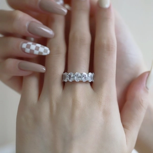 Macro detail of S925 sterling silver ring with oval-cut zircon stones in row setting