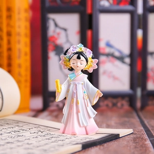 Macro shot of ancient style figurine holding a scroll with classical Chinese background