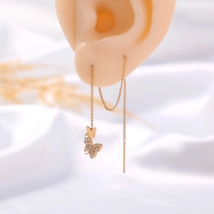 Elegant gold butterfly tassel earrings with sparkling cubic zirconia on a mannequin