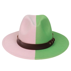 Detail of pink and green fedora hat with brown leather band and gold metal rivet