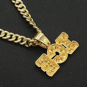 Macro shot of gold hip hop necklace featuring iced-out I Love U pendant and cuban link