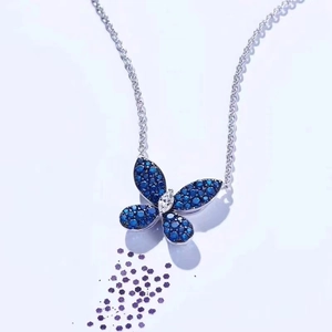 Elegant silver necklace with blue and white zircon butterfly pendant on white background