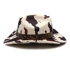 Detailed view of western cow print wool cowboy hat with studded brown decorative band