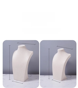 Detail view of large and small beige velvet bust displays with dimension specifications