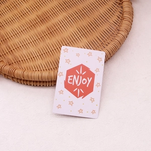 Rectangular floral greeting card with red Enjoy hexagon and small orange stars on a tray