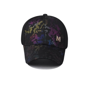 Close-up of fashionable breathable mesh baseball cap with colorful pattern and metal M logo