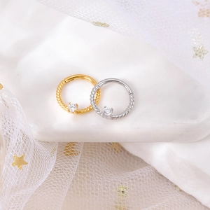 Twisted stainless steel nose rings in gold and silver finish with sparkling zircon stones