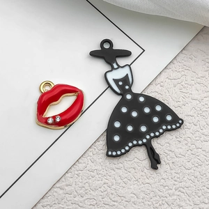 Detail of red lips charm and black polka dot dress pendant for DIY jewelry making