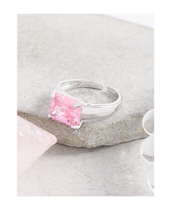 Macro shot of silver ring with large square pink gemstone and adjustable band detail