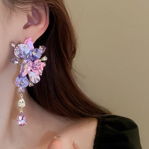Detail of purple flower drop earrings with rhinestones and hanging water drop crystals