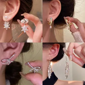 Elegant 925 silver needle gold earrings set with pearls, zircons and stylish charms