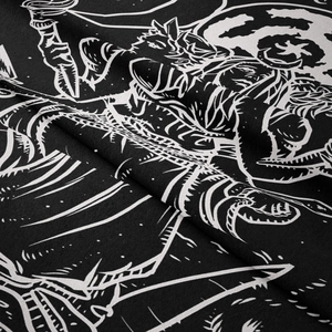 Macro detail of bohemian tapestry showing intricate black and white illustration on twill fabric