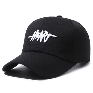 Black cotton baseball cap with white HEART embroidery shown from a 45-degree angle
