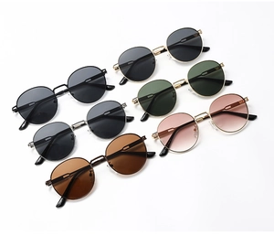 Multiple vintage round metal sunglasses in various frame colors and lens tints