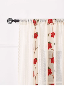 Detail of beige sheer curtain with red poinsettia floral embroidery and wavy scalloped edge