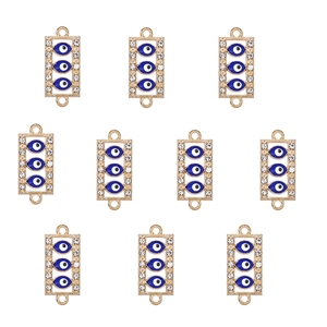 Macro view of 10 gold alloy evil eye connectors with blue stones and crystals for DIY jewelry