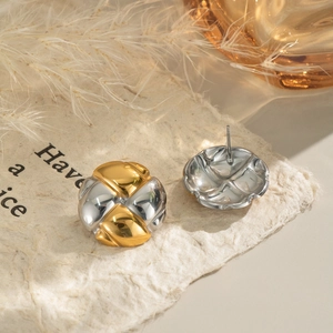 Detailed view of two-tone gold and silver round studs with twisted rope design